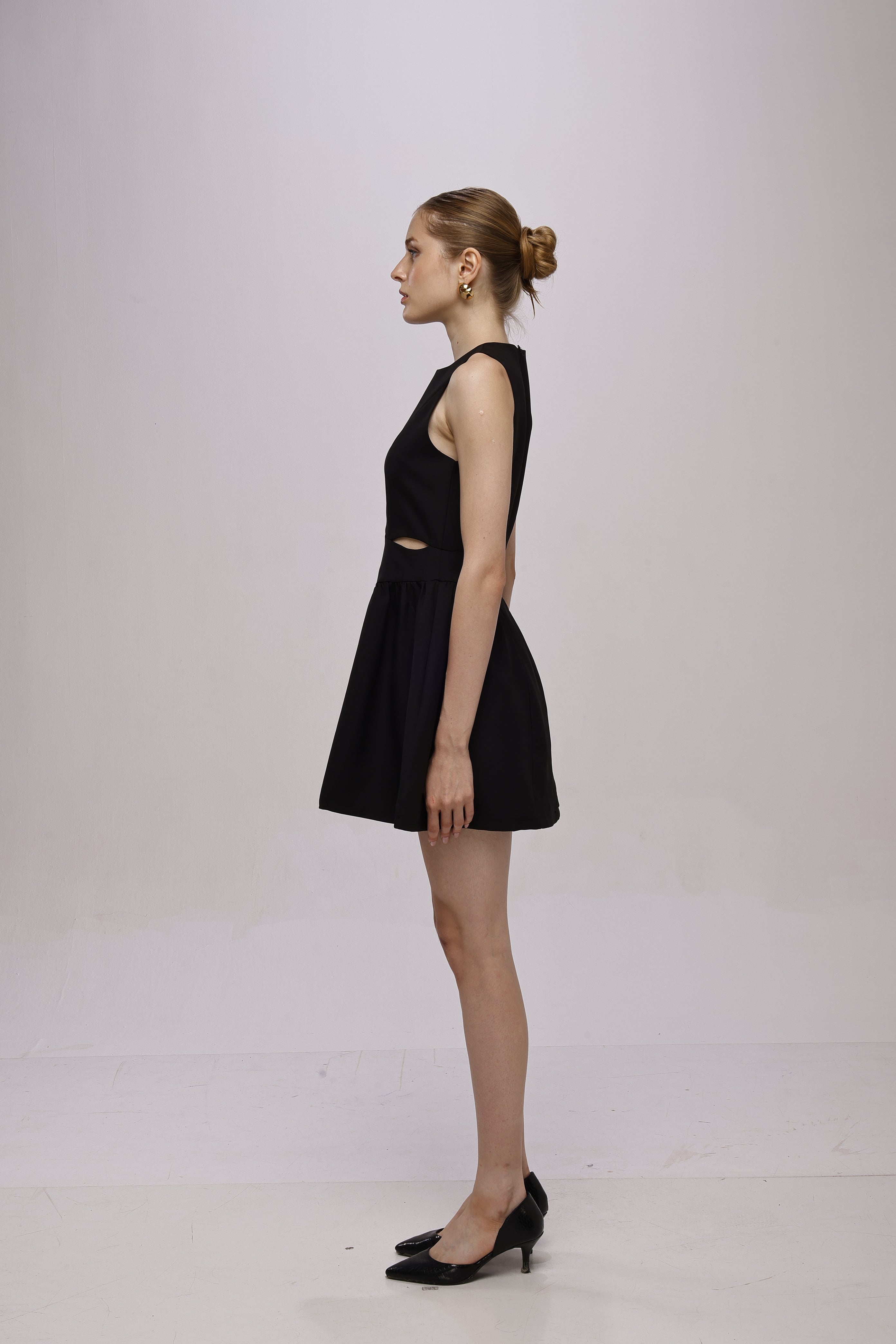 Black mini sleeveless A-line dress with waist cut-outs