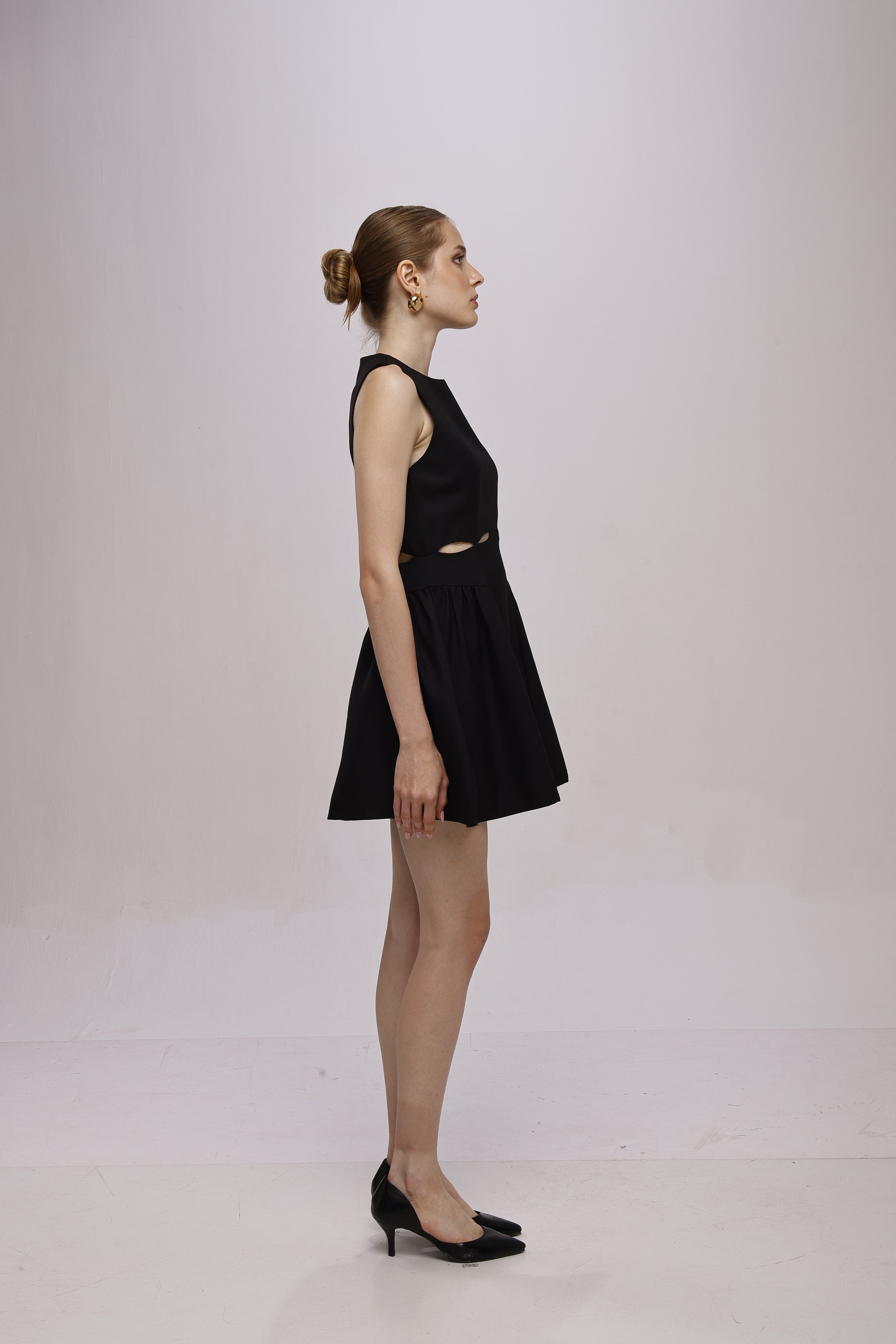 Black mini sleeveless A-line dress with waist cut-outs