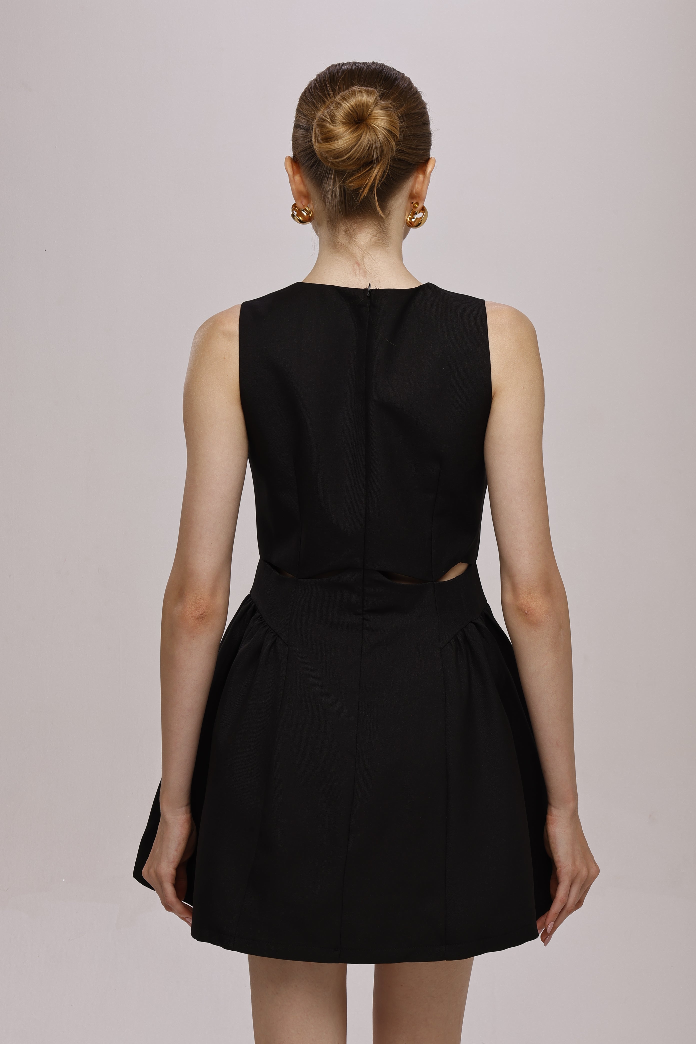 Black mini sleeveless A-line dress with waist cut-outs